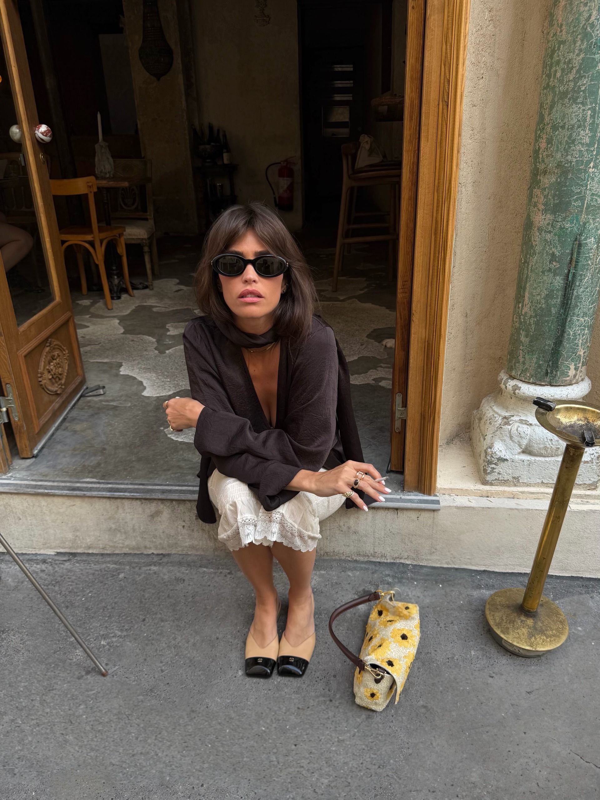 French woman in a brown top and two-tone shoes.