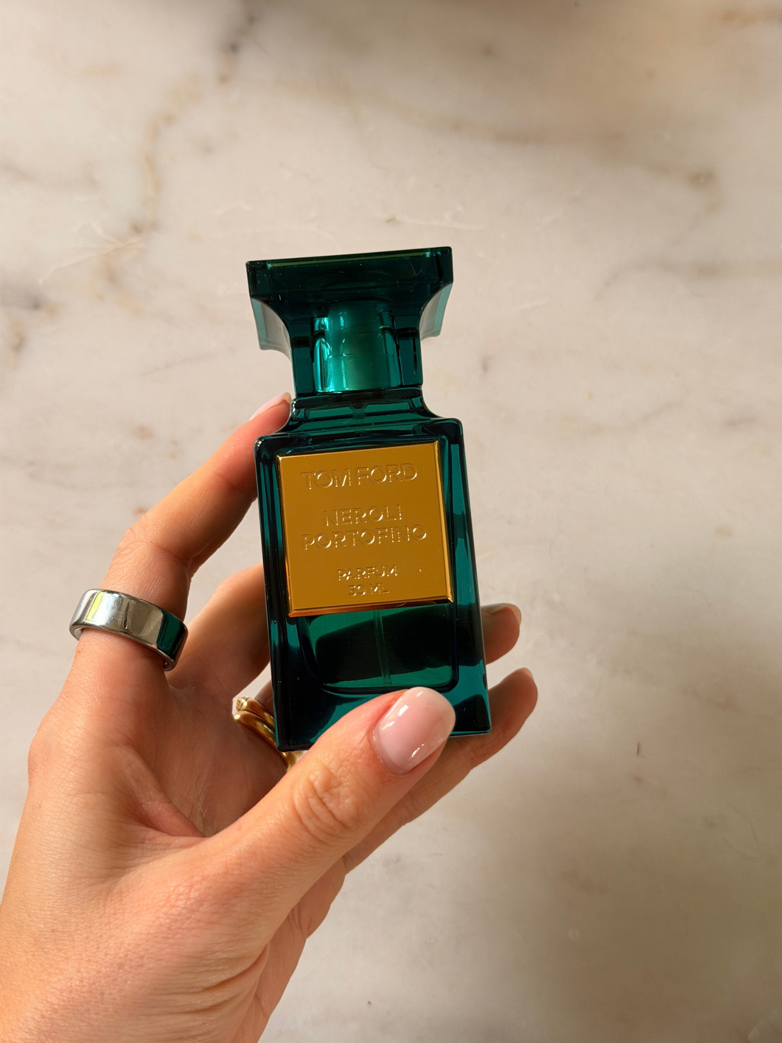 Freelance beauty editor Grace Day holding a bottle of Tom Ford Neroli Portofino