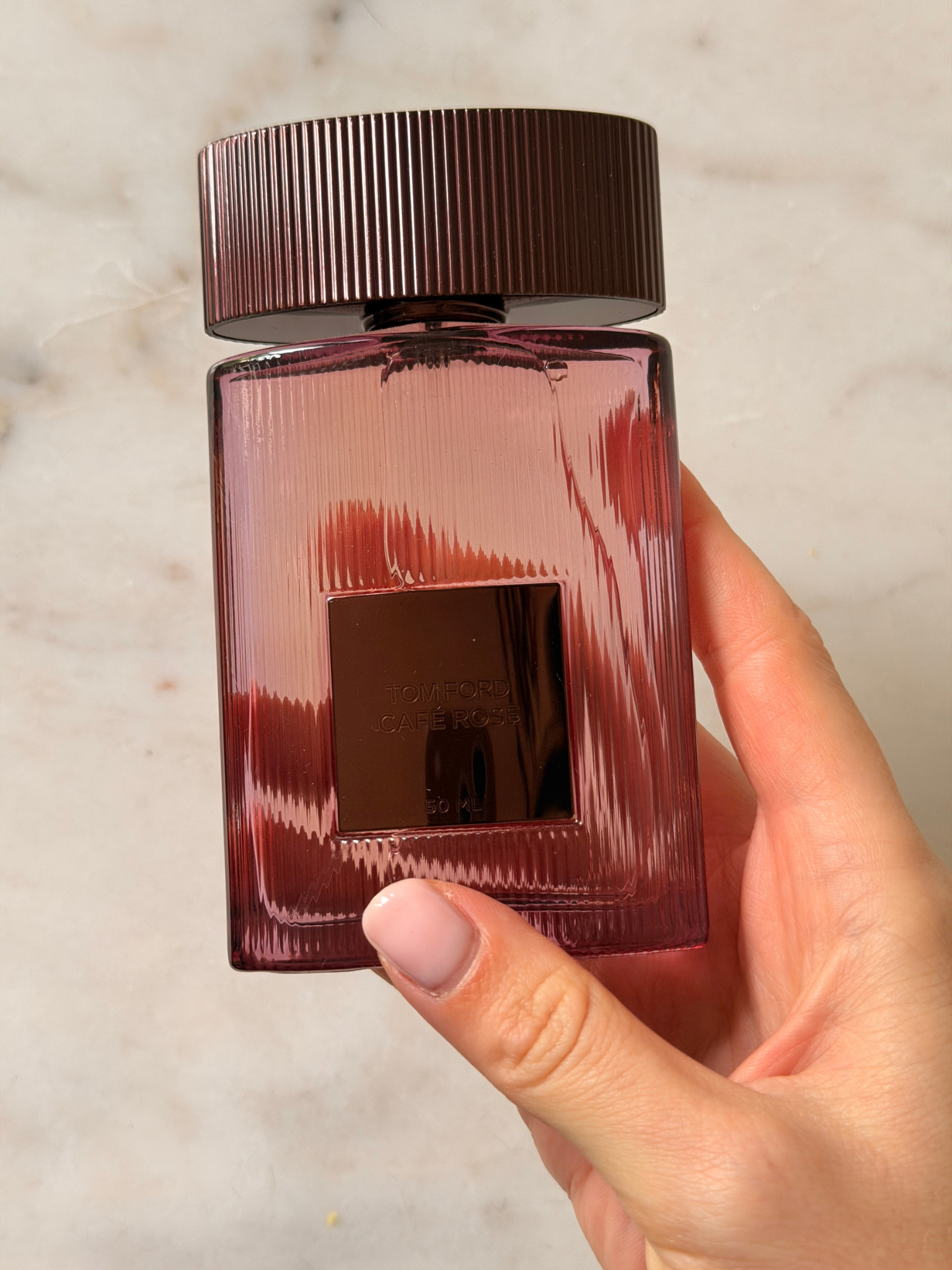 Freelance beauty editor Grace Day holding a bottle of Tom Ford Cafe Rose