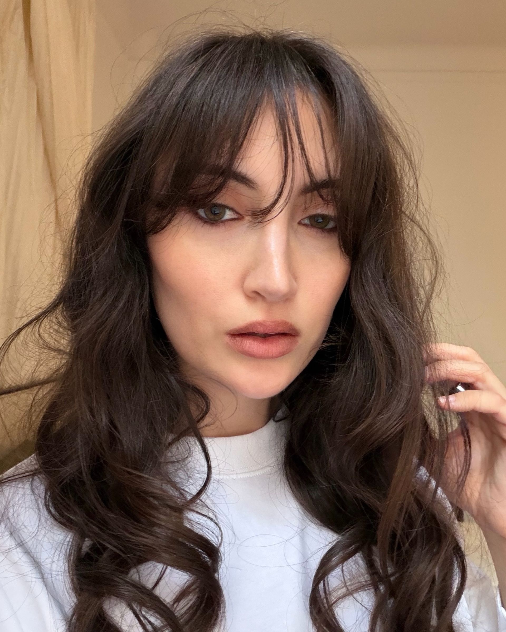 WWW associate beauty editor Alyssa Brascia's hair after cutting bangs like Daisy Edgar-Jones.