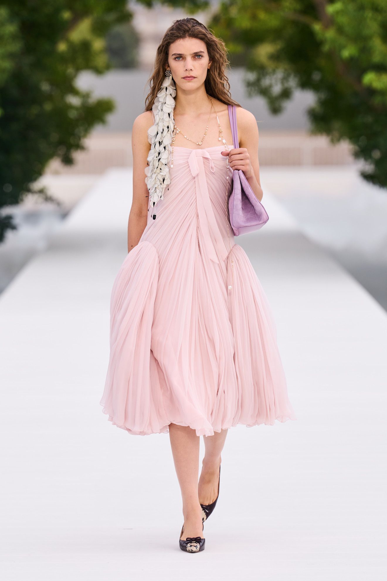 a woman wears a peplum dress at dior spring 2027.