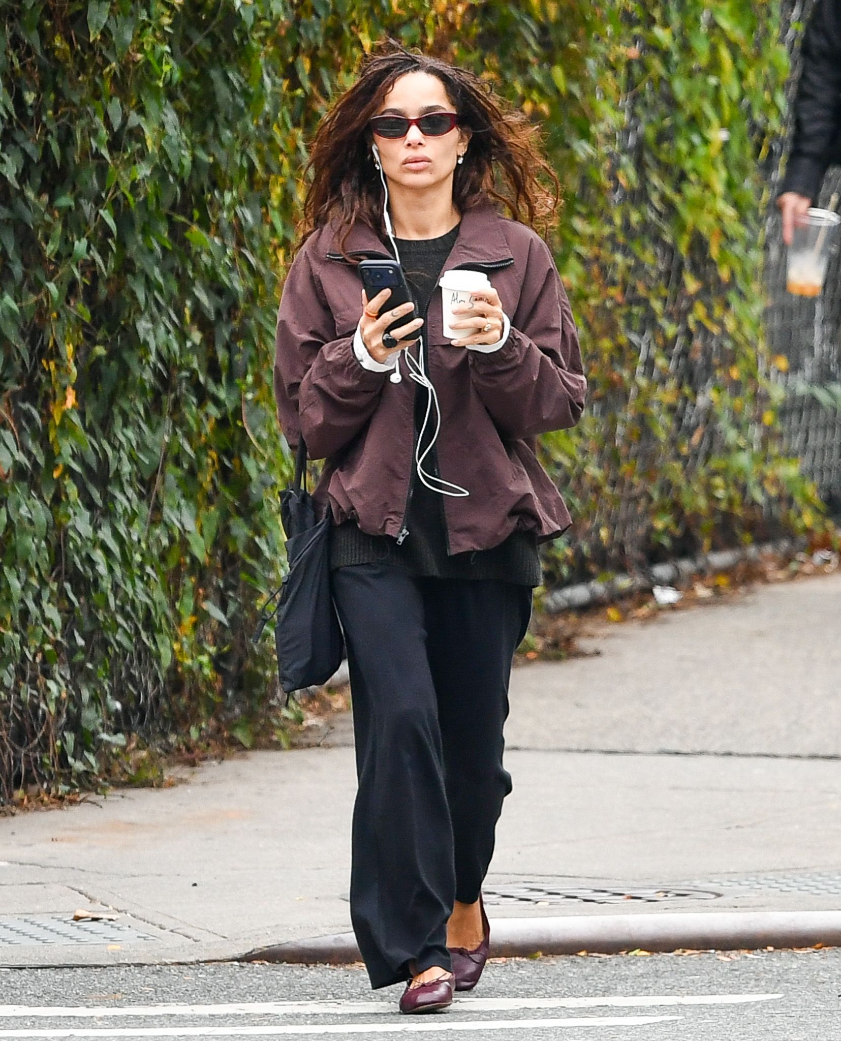 Zoe Kravitz wore a dark brown jacket over black top, black trousers and burgundy ballet flats.