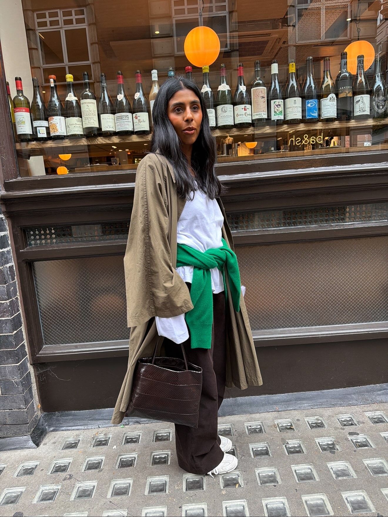 Woman wearing an eel-embossed bag.