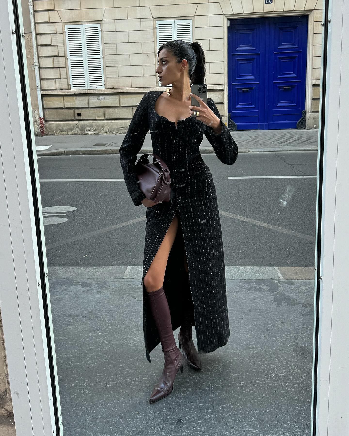 A woman in a long dress on the street.