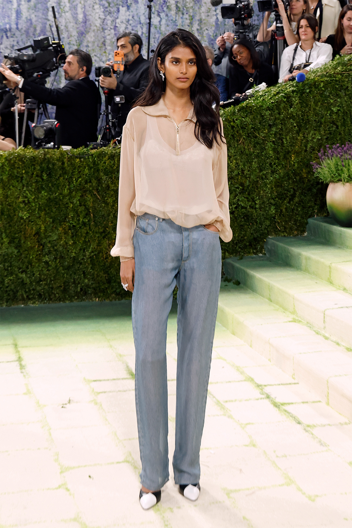Bhavitha Mandava wearing Chanel jeans, a sheer pink blouse and black-and-white court heels at the 2026 Met Gala
