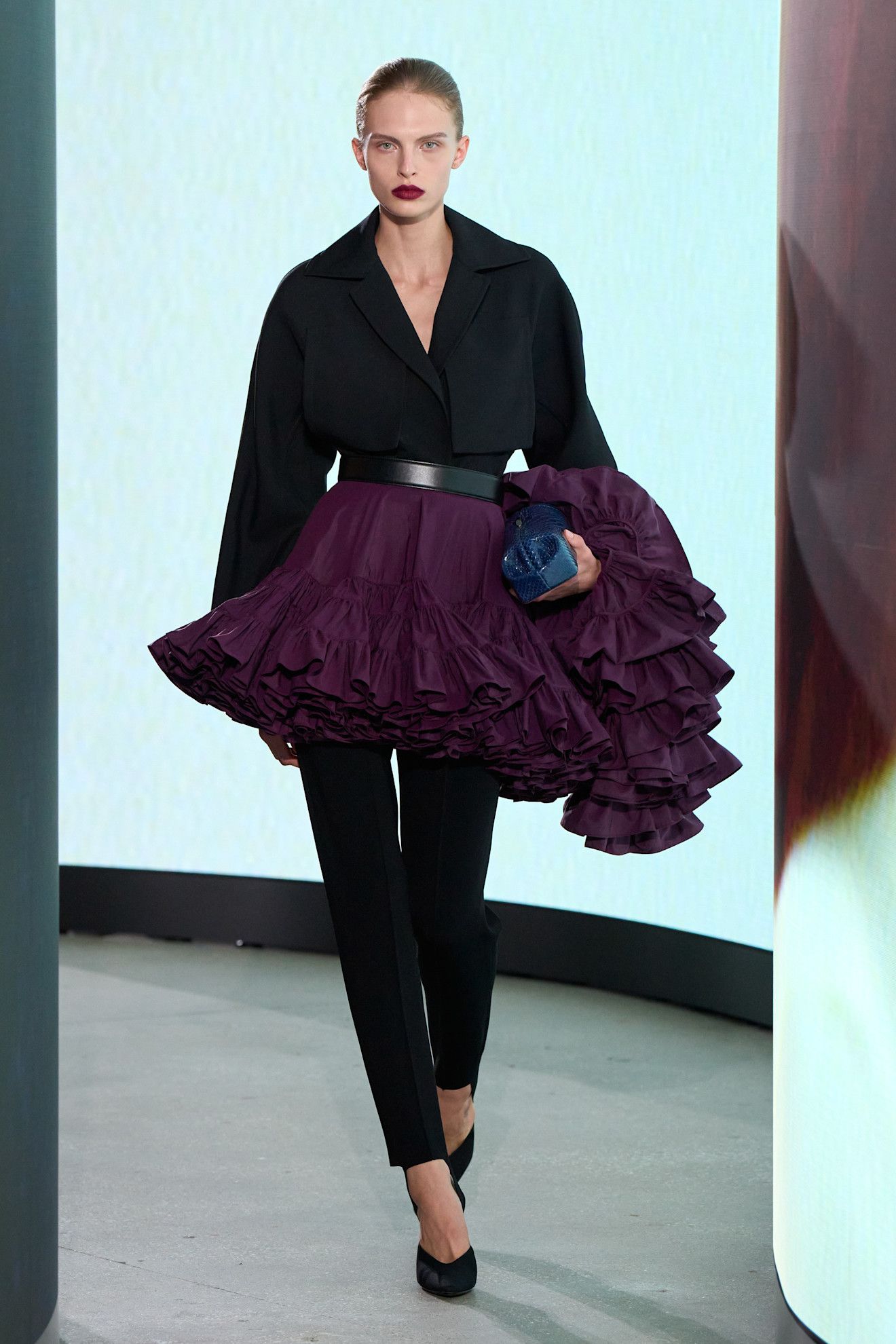 A model walking in the spring/summer 2027 Alaïa show during Paris Fashion Week wearing a jewel-tone look.