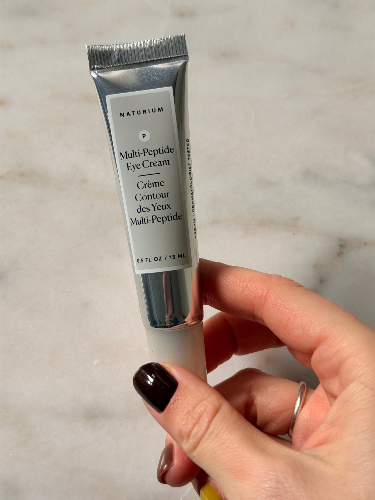 Freelance beauty editor Grace Day holding the Naturium eye cream