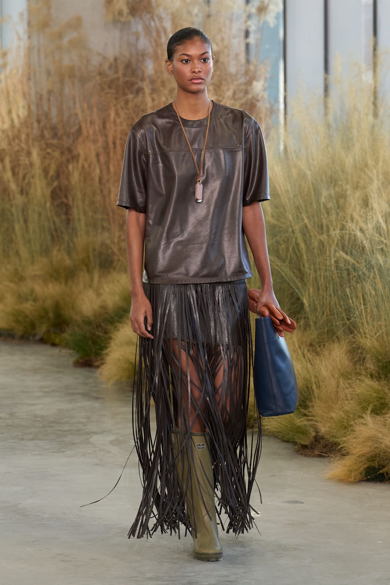 TWP fall/winter 2026 runway model wearing rain boots.