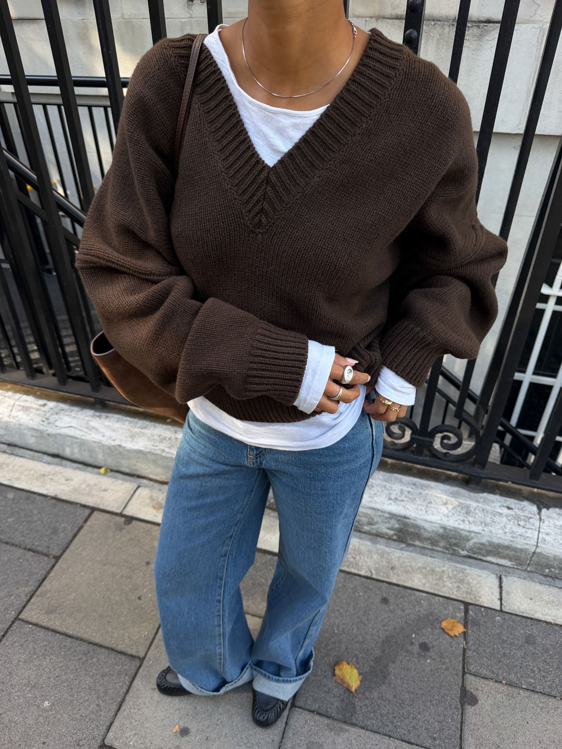 Woman in a brown sweater and jeans