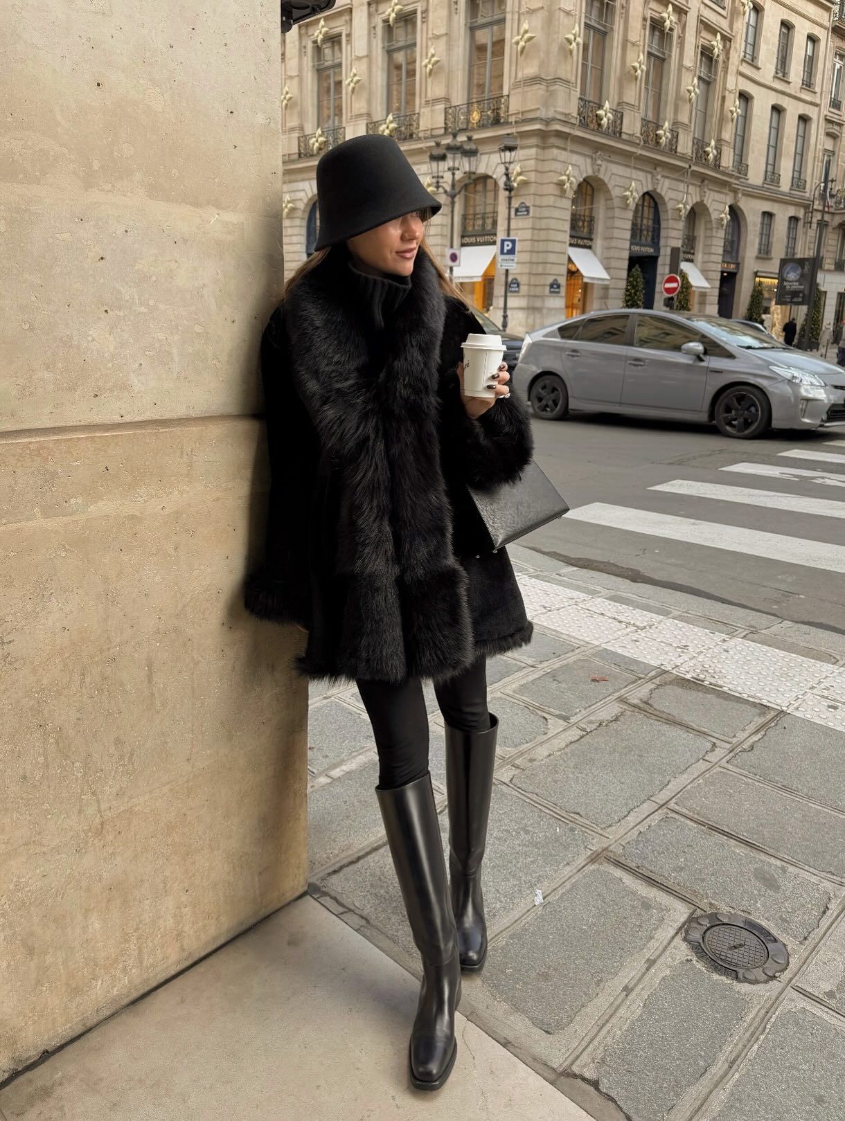 An image of @lovisabarkman  wearing a fur-effect coat with leggings and knee-high flat boots.