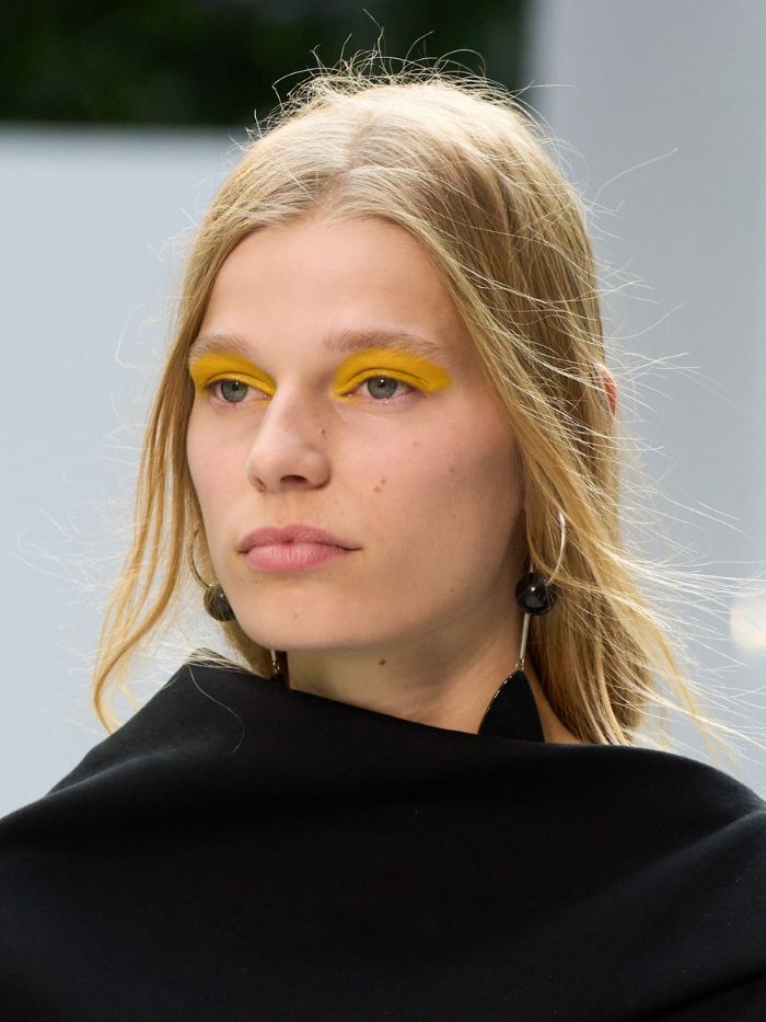 A close-up of the hair and makeup on the runway of the Michael Kors S/S 27 show