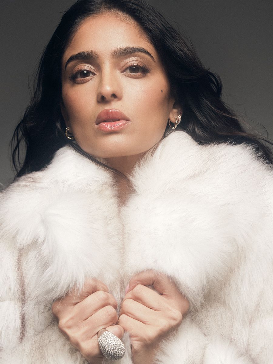 Mandeep Dhillon, photographed by Jack Waterlot, wearing a white furry coat.