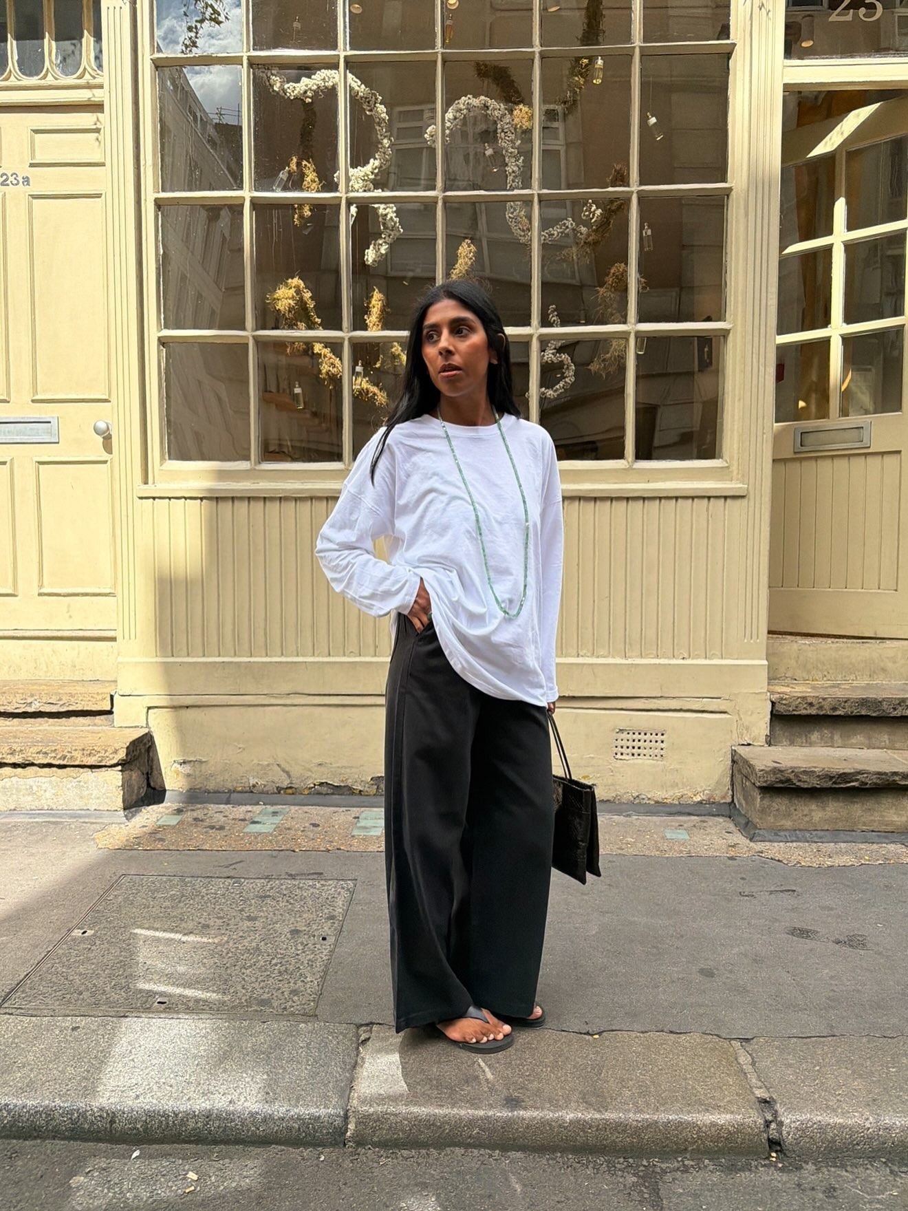 Woman in white long sleeve tee and black jeans